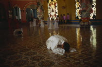 Adherants at prayer in Cao Dai Temple