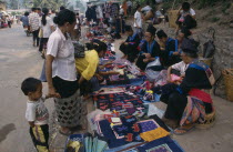 Hmong market vendors with colourful textile stalls Colorful