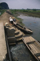 People moving boat over dyke