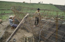 Men making boats out of metal and concrete
