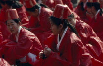 Sung Kyon Kwan University. Sukcheon Ceremony to consecrate confucius. Girls dancers in red sat on ground  University Founded 1398