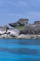 A rock which resembles the cartoon character perches next to other large boulders.