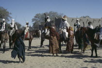 Kanimbo men on horses holding swords above their heads as a welcoming to the Chiefs son