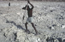 Boy cultivating grey coloured earthColored Gray