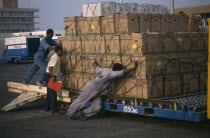 Loading crates of pineapples for export at Accra airport. West Africa