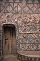 Detail of traditional mud architecture painted with red and black abstract geometric design and crocodile  the totem symbol of saving the life of a clan member.West Africa  Sirigu