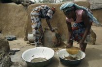Women filtering water to prevent guinea worm  a parasitic disease contracted when contaminated water is consumed and which can infect stagnant water.West Africa