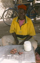 Man selling palm nuts.West Africa