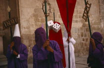 Penitents holding staffs displaying different symbols during Holy Week. Easter
