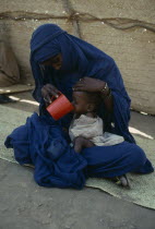 Woman with malnourished child at Red Cross feeding centre.