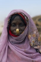 Head and shoulders portrait of Beni Amer nomad refugee woman.