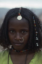 Portrait of Beni Amer Eritrean refugee girl wearing traditional jewellery.