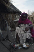 Ethiopian refugee woman spinning wool in International Labour Organisation sponsored self sufficiency scheme.ILO