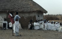 Coptic priest conducting open air othodox service in settlement for Ethiopian refugees.