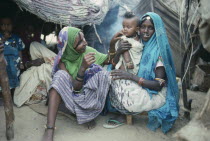 Beni Amer tribeswomen and child refugees in camp settlement.