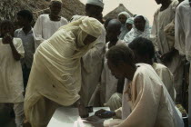 Signing for sorghum received in food distribution organised by CARE International with thumb print.UsheraUshera Kurdufan