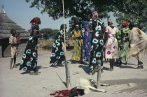 Dinka marriage ceremony  sacrificed goat and women dancing  with those from the same family wearing identical dresses.Indigenous Wedding