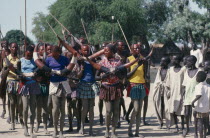 Dinka cattle festival celebrating the return of the herds to the Toich or pastureland.  Painted dancers holding decorated cattle horns.