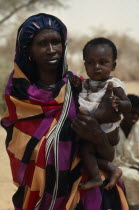 Portrait of Dar Hamid woman carrying child.  The Dar Hamid are nomadic Arab herders. Kurdufan