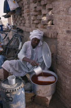 Cold drinks seller at roadside stall.