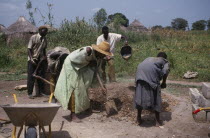 Men and women building village school