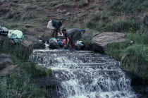 Girls doing laundry in river