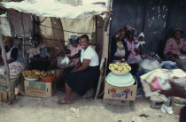 Women at market stall smiling and laughing