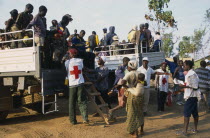 Camp for Sierra Leonean refugees. People arriving in trucks at new camp amomgst red cross workers