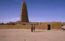 The Grand Mosquee.  Originally built in 1515 and then renovated and rebuilt in 1844 in the original style with wooden support beams protruding from single minaret.Agadez Moslem