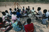 Mobile clinic giving advice to mother and baby group.