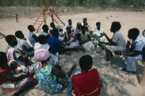 Mobile clinic giving advice to mother and baby group.