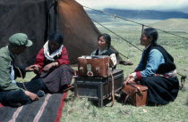Tibetan travelling doctors visiting nomad women in grassland encampment.