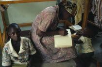 Trainee village health worker writing notes.