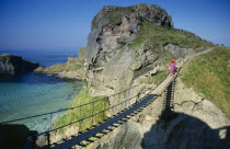 Visitors crossing narrow rope bridge on the Irish coast.NorthernNorthernNorthernNorthernNorthern