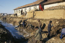 Juche clearing irrigation canal damaged by 1995 floods.