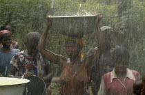 Women during wet season harvesting rainwater as part of UNICEF water project.
