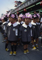Asakusa. Kannon Temple.Nursery school children dressed in uniforms and flower head bands for the Hara Matsuri Flower Festival celebrating buddhas Birthday.Also known as Senso-ji Temple