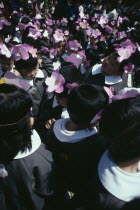 Asakusa. Nursery school children in uniforms and flower head bands celebrating the Flower Festival at Asakusa Kannon Temple for Buddhas birthday.