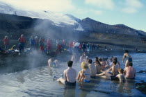 Tourists bathing in hot springs at Pendulum Cove.