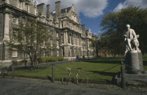 Trinity College.  Exterior facade and grounds with chained bicycle and statue of mathmatician and theologian George Salmon provost of the college 1888-1904.Eire Republic Eire Republic Eire Republic...