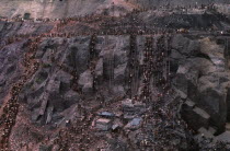 General view of the many workers at the biggest hand dug hole  known as the cava  digging for gold. Ladders resting against the rock face. Brasil