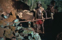 Miners  one with a long spade at the goldmine of Fofoca where goldbearing rock is mixed with copper. Brasil
