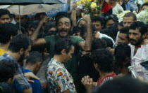 At the funeral of the rubber tapper  Raimundo Barros  his cousin  waves his arms in grief amongst the crowd. Brasil