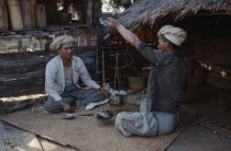 Two men sat down  weighing and selling opium to a small merchant.drugs Burma