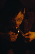 A gang member smoking heroin through a matchbox.drugs