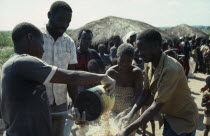 Displaced people receiving EEC maize monitered by Action Aid.refugee African Eastern Africa Kids Mozambiquean