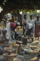 Women selling beans and pulses at street market.African Eastern Africa Mozambiquean Female Woman Girl Lady Female Women Girl Lady