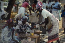 Street market scene with women selling beans.African Eastern Africa Mozambiquean Female Woman Girl Lady Female Women Girl Lady
