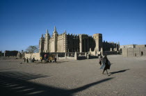 Grand Mosque.  Exterior with passer by casting long shadow. Moslem