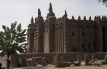 The Grand Mosque.  Mud plastered exterior with sheep lying in shade of walls in foreground. Moslem